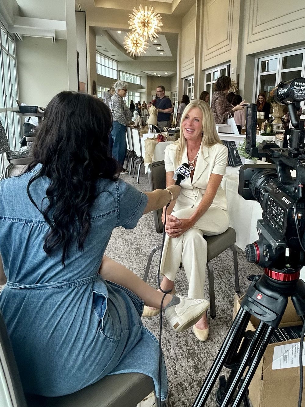 Laura Burkett being interviewed by a WKBN 27 First News reporter at the Women Rising Summit